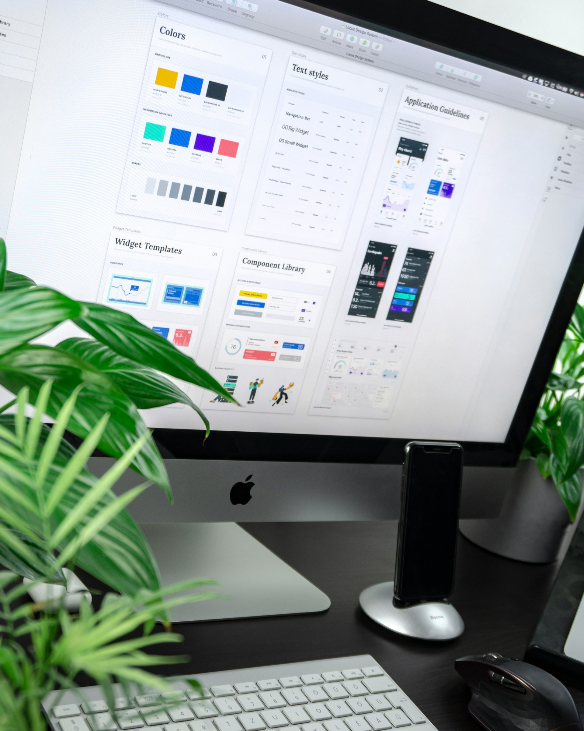UI design tools and interface components on a monitor.